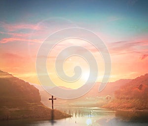 Silhouette cross on Calvary mountain sunset background. Easter concept