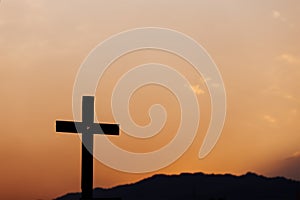 Silhouette of cross on mountain at sunset. concept of religion