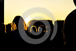 Silhouette of crowd people in city on a sunet