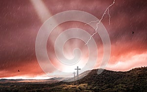 Silhouette of crucifix cross at sunset time with holy light and thunderstorm background