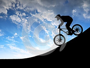 Silhouette of the cyclist on downhill bike