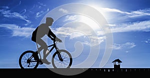 Silhouette of the cyclist riding a road bike