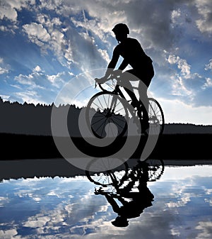 Silhouette of the cyclist riding a road bike