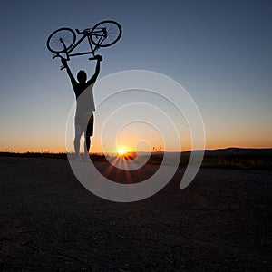 Silhouette of cyclist in sunset
