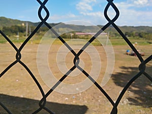 Silhouette of a Cyclone Fence