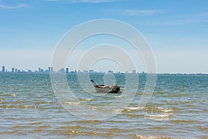 Silhouette of Da Nang city with lonely basket boat