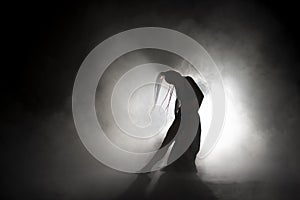 Silhouette dancer performing dance figures.