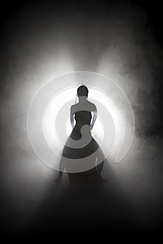 Silhouette dancer performing dance figures.