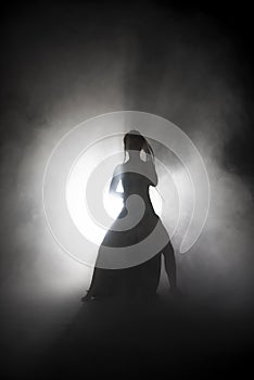 Silhouette dancer performing dance figures.