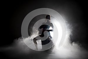 Silhouette dancer performing dance figures.