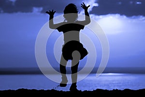 Silhouette of dancing girl on moon night