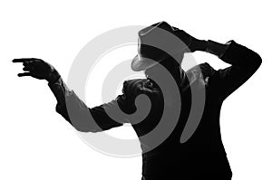 Silhouette of dancing private detective. Agent stay side to camera and looks like mafioso Al Capone. Criminal or mob scene. Studio