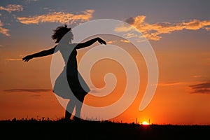 Silhouette of dancing woman on sunset