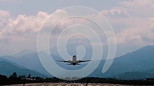 Silhouette of departing airplane, airliner is flying in the dramatic cloudy sky