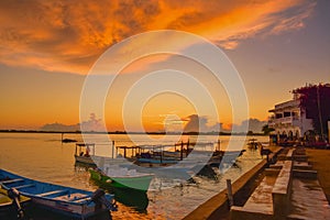 Silhouette of Dhows and boats moored at shore against buildings in Shela Beach, Lamu Island, Kenya