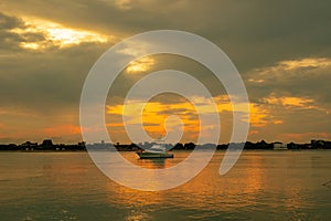 Silhouette of Dhows and boats moored at shore against buildings in Shela Beach, Lamu Island, Kenya