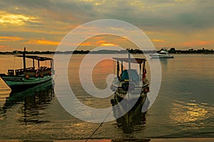 Silhouette of Dhows and boats moored at shore against buildings in Shela Beach, Lamu Island, Kenya