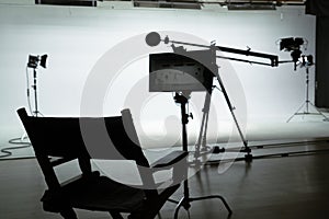 Silhouette of a Director's Chair in a Film Studio Backstage shot.