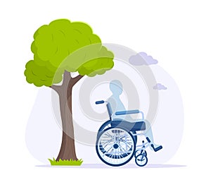 Silhouette of disabled man sitting in wheelchair under green tree