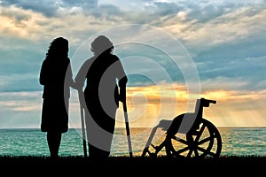 Silhouette of a disabled wheelchair near peepers and near sea. Concept of a disabled person and home for elderly