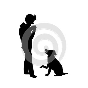 Silhouette of a dog begging for food while owner is eating