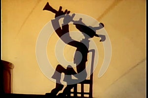 Silhouette of dog playing the clarinet