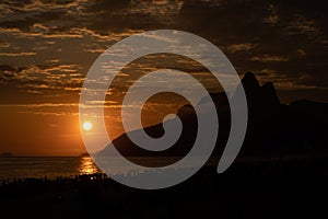 Silhouette of Dois Irmaos during an amazing sunset over Ipanema beach in Rio de Janeiro