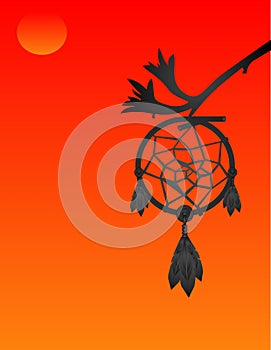 Silhouette of a dream catcher at sunset