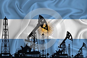 Silhouette of drilling rigs and oil derricks on the background of the flag of Argentina. Oil and gas industry. The concept of oil