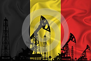 Silhouette of drilling rigs and oil derricks on the background of the flag of Belgium. Oil and gas industry. The concept of oil