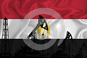 Silhouette of drilling rigs and oil derricks on the background of the flag of Egypti. Oil and gas industry. The concept of oil