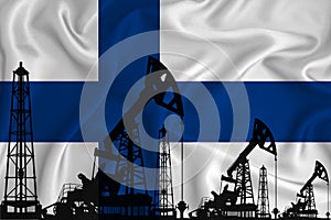 Silhouette of drilling rigs and oil derricks on the background of the flag of Finland. Oil and gas industry. The concept of oil