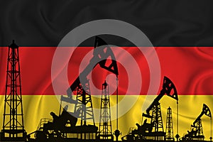 Silhouette of drilling rigs and oil derricks on the background of the flag of germany. Oil and gas industry. The concept of oil