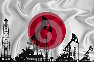 Silhouette of drilling rigs and oil derricks on the background of the flag of Japan. Oil and gas industry. The concept of oil