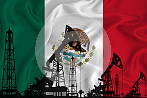 Silhouette of drilling rigs and oil derricks on the background of the flag of Mexico. Oil and gas industry. The concept of oil