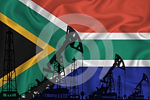 Silhouette of drilling rigs and oil derricks on the background of the flag of South Africa. Oil and gas industry. The concept of