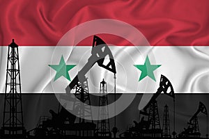 Silhouette of drilling rigs and oil derricks on the background of the flag of Syria. Oil and gas industry. The concept of oil