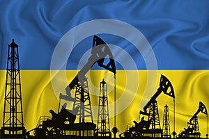 Silhouette of drilling rigs and oil derricks on the background of the flag of Ukraine. Oil and gas industry. The concept of oil