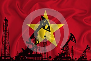 Silhouette of drilling rigs and oil derricks on the background of the flag of Vietnam. Oil and gas industry. The concept of oil