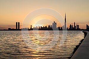 Silhouette of Dubai Downtown at sunset.