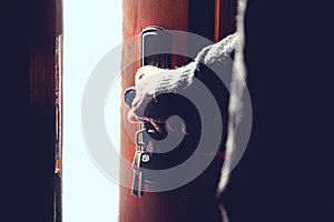 Silhouette of an elderly man opening the door