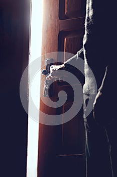Silhouette of an elderly man opening the door