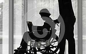 Silhouette elderly woman reading a book with her son take car