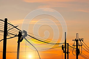 Silhouette of Electrician lineman worker at climbing work on the electric post power pole, Electrician checking lighting to the