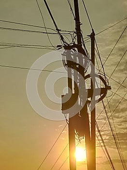 silhouette of electricity pole In the afternoon when the sun sets. photo