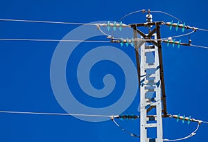 Silhouette electricity post on the background of blue sky