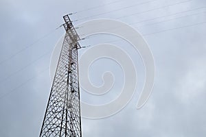 Silhouette of electricity post on blue sky background,low angle shot,high voltage electric pole, power supply cloudy d