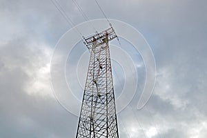 Silhouette of electricity post on blue sky background,low angle shot,high voltage electric pole, power supply cloudy d