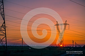Silhouette electricity pylons photo