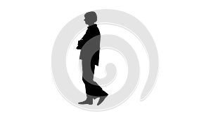 Silhouette Elegant senior woman dressed in white shirt with glasses and bag walking by.